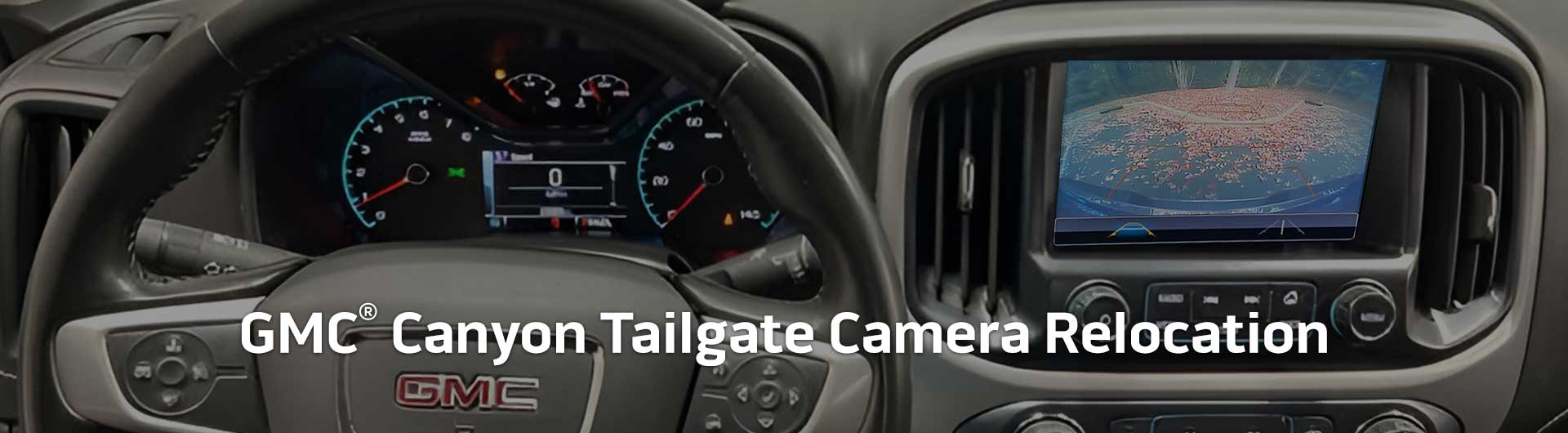 An image showing the dashboard monitor of a GMC Canyon with the view from the backup camera on display.