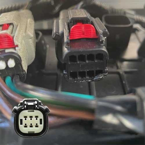 An image of a connector under a vehicle showing that the interior of the plug has 8 pins