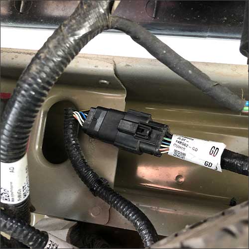 An image of the black factory camera interface harness for a Ford F-150 with a automatically-lowering tailgate