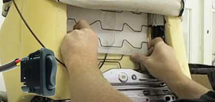 An image showing a person installating a lunbar support air bladder into the seat of an automobile.